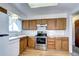 Bright kitchen features wood cabinets, white countertops, and stainless-steel appliances at 301 S Troy St, Aurora, CO 80012