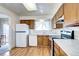 Bright kitchen featuring a stainless steel range, wood cabinets, and white appliances at 301 S Troy St, Aurora, CO 80012