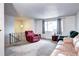 Living room with neutral carpet, natural light, and plenty of space for furniture and décor at 301 S Troy St, Aurora, CO 80012