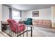 Comfortable living room with a neutral carpet, a large window, and a sofa, perfect for relaxation at 301 S Troy St, Aurora, CO 80012