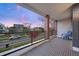 This balcony has wood-look deck boards, a brick support, and outdoor chair at 3928 Vrain St, Denver, CO 80212