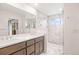Modern bathroom featuring a double vanity, marble walk-in shower with glass door, and recessed lighting at 3928 Vrain St, Denver, CO 80212