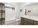 A well-lit bathroom features tile flooring, shower-tub combo, and a modern vanity at 3928 Vrain St, Denver, CO 80212