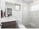 Bright bathroom features a sleek glass-enclosed shower, modern vanity, and natural light from the window at 3928 Vrain St, Denver, CO 80212