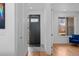 Welcoming entryway with stylish tile, leading to a bright and open living area with hardwood floors and an open door at 3928 Vrain St, Denver, CO 80212