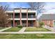 Modern townhome exterior with brick facade, balconies, and well-manicured front lawn at 3928 Vrain St, Denver, CO 80212