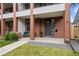 Inviting front porch with brick accents, seating area, and well-maintained landscaping at 3928 Vrain St, Denver, CO 80212