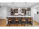 Bright kitchen featuring a large island with barstool seating, stainless steel appliances, and modern pendant lights at 3928 Vrain St, Denver, CO 80212