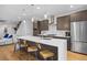 Contemporary kitchen boasts a spacious island, stainless steel appliances, pendant lights, and barstool seating at 3928 Vrain St, Denver, CO 80212