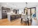 Modern kitchen and dining area featuring a spacious island, pendant lighting, and a dining table nearby at 3928 Vrain St, Denver, CO 80212