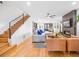Open living area with hardwood floors, fireplace, and stairs to upper level at 3928 Vrain St, Denver, CO 80212