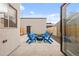 Private patio area with comfortable blue Adirondack chairs arranged around a small table, perfect for relaxing at 3928 Vrain St, Denver, CO 80212