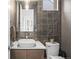 Stylish powder room with patterned accent wall, modern vanity, and elegant lighting at 3928 Vrain St, Denver, CO 80212