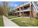 Modern townhomes with striking brick accents, balconies, and well-maintained lawns on a tree-lined street at 3928 Vrain St, Denver, CO 80212