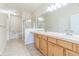 A relaxing bathroom featuring double sinks, soaking tub, and glass enclosed shower at 2215 Calais Dr # G, Longmont, CO 80504