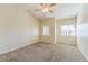 Bright bedroom with neutral walls, ceiling fan, and great natural light from large windows at 2215 Calais Dr # G, Longmont, CO 80504