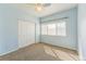 This bright bedroom features neutral carpet, a ceiling fan and lots of natural light at 2215 Calais Dr # G, Longmont, CO 80504