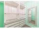 Walk-in closet featuring custom shelving, drawers, and a full-length mirror at 2215 Calais Dr # G, Longmont, CO 80504