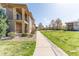 Beautiful view of condo exteriors and walkways surrounded by lush green lawns and trees at 2215 Calais Dr # G, Longmont, CO 80504