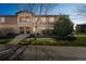 Inviting condo exterior with well-manicured lawn and decorative stone accents enhancing the facade at 2215 Calais Dr # G, Longmont, CO 80504