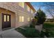 Inviting exterior of a condo featuring stone accents, dark door, and well-kept landscaping at 2215 Calais Dr # G, Longmont, CO 80504