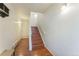 Hallway features hardwood floors, white staircase, and plenty of lighting at 2215 Calais Dr # G, Longmont, CO 80504