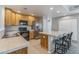 Well-lit kitchen features stainless steel appliances and a breakfast bar with stool seating at 2215 Calais Dr # G, Longmont, CO 80504