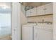 Laundry room with overhead cabinets, a washer and dryer at 2215 Calais Dr # G, Longmont, CO 80504
