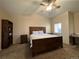 Inviting main bedroom with wood bedroom set, ceiling fan, and bright window at 2215 Calais Dr # G, Longmont, CO 80504