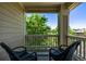 Relaxing balcony with wicker chairs and a serene view of lush green trees at 11300 Night Heron Dr, Parker, CO 80134