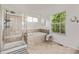 Beautiful bathroom with tiled shower, soaking tub under window, and light neutral colors at 11300 Night Heron Dr, Parker, CO 80134