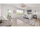 Bright bedroom with ceiling fan, large windows, and access to a private balcony with outdoor views at 11300 Night Heron Dr, Parker, CO 80134