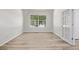 Bright bedroom featuring hardwood floors, a large window, and a french door at 11300 Night Heron Dr, Parker, CO 80134