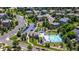 Aerial view of community pool with ample lounge chairs, kiddie pool, and extensive parking at 11300 Night Heron Dr, Parker, CO 80134