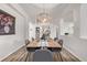 Elegant dining room with hardwood floors, modern lighting, and ample natural light at 11300 Night Heron Dr, Parker, CO 80134