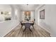 Beautiful dining room with a modern chandelier, hardwood floors, and ample natural light at 11300 Night Heron Dr, Parker, CO 80134