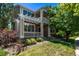 Charming two-story home with a pergola-covered porch, lush landscaping, and a well-maintained lawn at 11300 Night Heron Dr, Parker, CO 80134