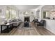 Inviting living room featuring a fireplace, neutral decor, hardwood floors, and plenty of natural light at 11300 Night Heron Dr, Parker, CO 80134
