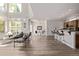 Bright open-concept living room featuring high ceilings, modern decor, and a breakfast bar at 11300 Night Heron Dr, Parker, CO 80134