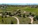 An aerial view of a community walking path surrounded by lush green space in a well maintained neighborhood at 11300 Night Heron Dr, Parker, CO 80134