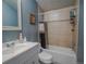 Bathroom featuring a shower-tub combo, decorative tile, and bright mirror at 15682 Morris Ave, Fort Lupton, CO 80621