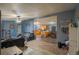 Open concept living room flows into the kitchen featuring sleek countertops and modern appliances at 15682 Morris Ave, Fort Lupton, CO 80621