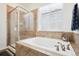 Bright bathroom featuring a soaking tub and separate glass shower at 771 Dutton Ct, Castle Rock, CO 80104