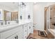Bright bathroom with a double vanity, tile flooring, and a glass shower at 771 Dutton Ct, Castle Rock, CO 80104