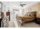 Comfortable bedroom with a trey ceiling, ceiling fan, and a large window at 771 Dutton Ct, Castle Rock, CO 80104