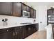 Gourmet kitchen with stainless steel appliances, white countertops, and dark wood cabinetry at 771 Dutton Ct, Castle Rock, CO 80104