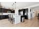 Modern kitchen featuring a large island, stainless steel appliances, and stylish dark cabinets at 771 Dutton Ct, Castle Rock, CO 80104