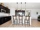 Kitchen island with pendant lighting, white countertops, and seating for casual dining at 771 Dutton Ct, Castle Rock, CO 80104