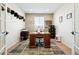 Bright home office featuring a wood desk, neutral paint, and a warm, patterned rug at 771 Dutton Ct, Castle Rock, CO 80104
