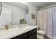 Bathroom featuring neutral colors, decorative paisley shower curtain, and updated fixtures at 22336 E Bellewood Dr, Aurora, CO 80015